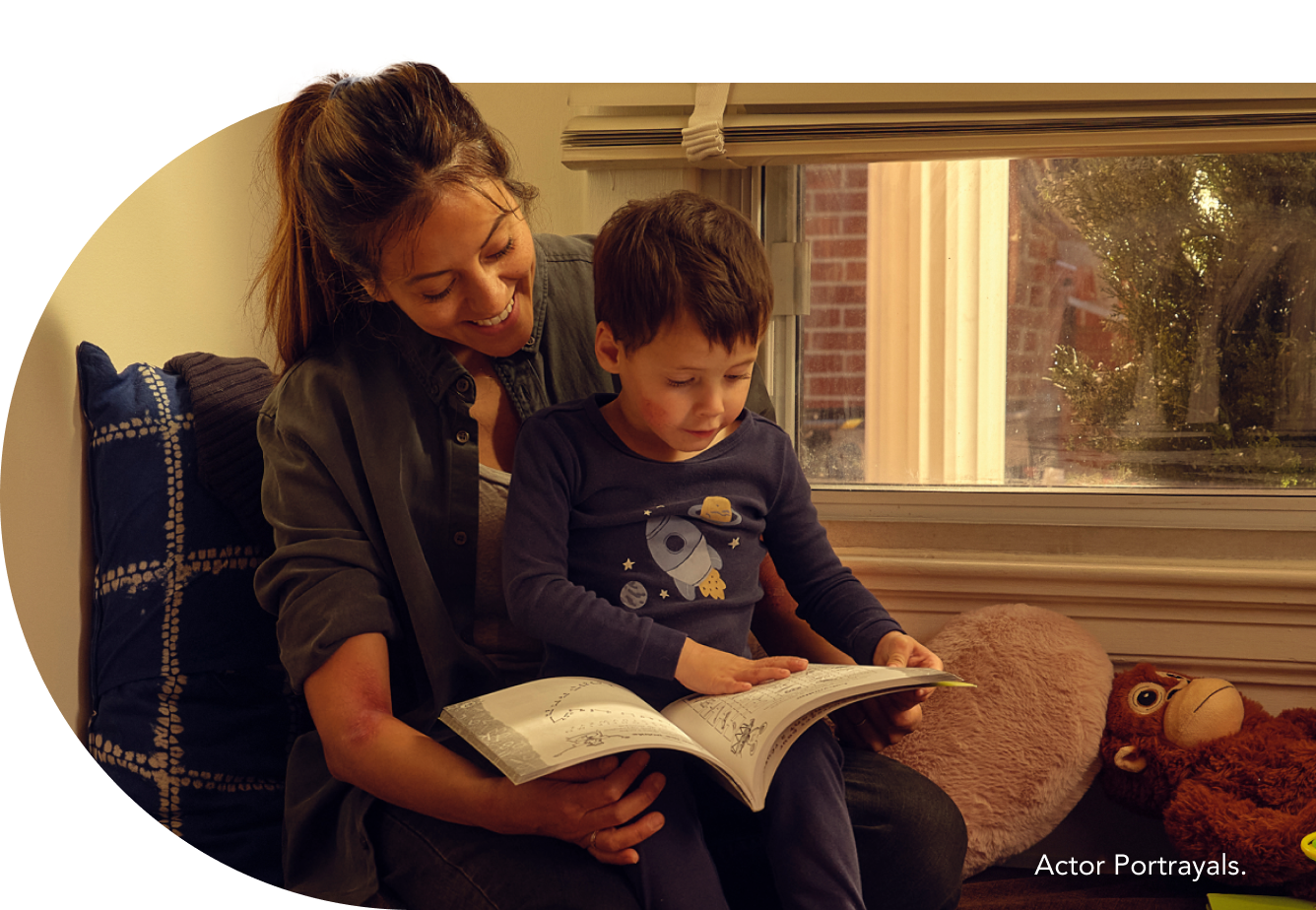 Mother and child reading a book together